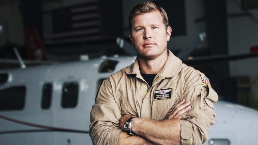 U.S. Senate candidate Tim Sheehy poses in hangar.