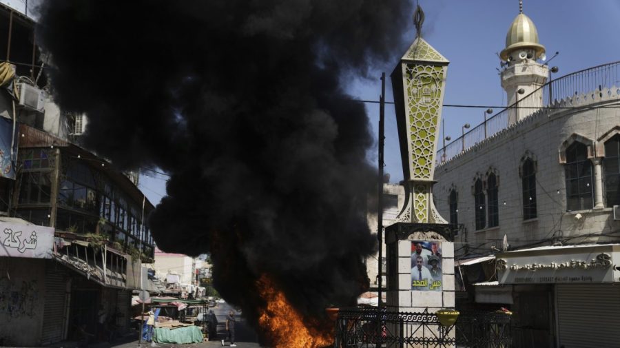 Tires burn during an Israeli military raid in the militant stronghold of Jenin refugee camp in the occupied West Bank, Monday, July 3, 2023. Israeli drones struck targets in the area early Monday and hundreds of troops were deployed. Palestinian health officials said at least five Palestinians were killed. (AP Photo/Nasser Nasser)