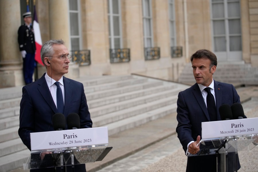 French President Emmanuel Macron, right, and NATO Secretary General Jens Stoltenberg speak to reporters before their talks Wednesday, June 28, 2023 at the Elysee Palace in Paris. NATO Secretary-General Jens Stoltenberg said earlier that he has called a meeting of senior officials from Turkey, Sweden and Finland on July 6 to try to overcome Turkish objections to Sweden joining the military organization. (AP Photo/Christophe Ena)