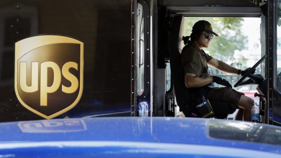 A United Parcel Service delivery driver steers his truck, Friday, June 30, 2023, in the East Boston neighborhood of Boston. (AP Photo/Michael Dwyer)