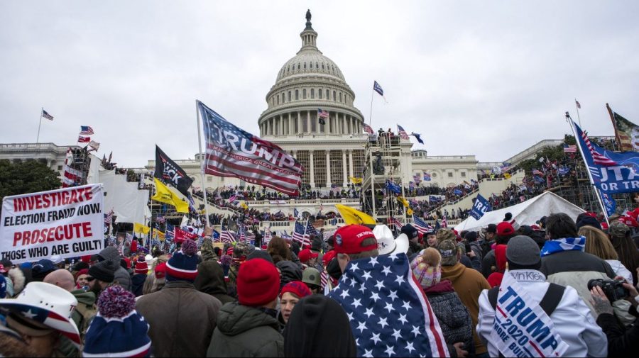 FILE - Rioters loyal to President Donald Trump rally at the U.S. Capitol in Washington on Jan. 6, 2021. Federal prosecutors say Taylor Taranto, 37, who prosecutors say participated in the Jan. 6, 2021 riot at the U.S. Capitol and arrested last week near the home of former President Barack Obama, told followers on his YouTube live stream that he was looking to get a “good angle on a shot” and that he was trying to locate the “tunnels underneath their houses” shortly before he was taken into custody by the Secret Service. (AP Photo/Jose Luis Magana, File)