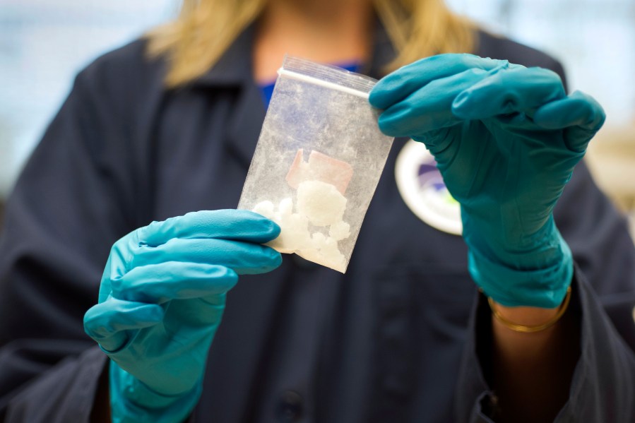 FILE - A bag of 4-fluoro isobutyryl fentanyl which was seized in a drug raid is displayed at the Drug Enforcement Administration (DEA) Special Testing and Research Laboratory in Sterling, Va., on Aug. 9, 2016. (AP Photo/Cliff Owen, File)