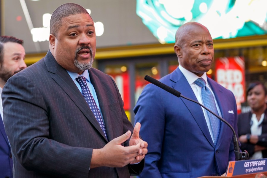 FILE — Manhattan District Attorney Alvin Bragg, left, and New York City Mayor Eric Adams, speak at a News conference in New York's Times Square, Oct. 11, 2022. Bragg has announced an indictment of several people who allegedly participated in a straw donor scheme to raise money for Adams, Friday, July 7, 2023. (AP Photo/Mary Altaffer, File)