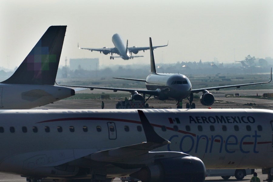 FILE - Passenger planes take off from Benito Juarez International Airport in Mexico City, May 12, 2022. The Navy, which took charge of security at the international airport, more than a year ago, will have control of everything else, from customs and immigration to handling luggage and cleaning bathrooms. (AP Photo/Marco Ugarte, File)