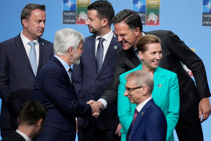 Netherland's Prime Minister Mark Rutte, right, shakes hands with Czech Rebublic's President Petr Pavel, second left, during a group photo at a NATO summit in Vilnius, Lithuania, Tuesday, July 11, 2023. NATO's summit began Tuesday with fresh momentum after Turkey withdrew its objections to Sweden joining the alliance, a step toward the unity that Western leaders have been eager to demonstrate in the face of Russia's invasion of Ukraine. (AP Photo/Pavel Golovkin)