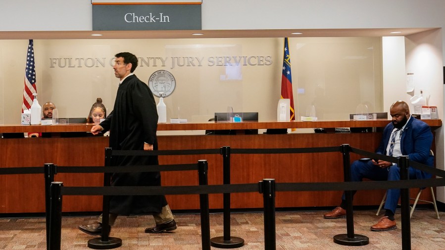 Fulton County Superior Court Judge Robert McBurney walks in the Fulton county courthouse, Tuesday, July 11, 2023, in Atlanta. A grand jury being seated Tuesday in Atlanta will likely consider whether criminal charges are appropriate for former President Donald Trump or his Republican allies for their efforts to overturn his 2020 election loss in Georgia. (AP Photo/Brynn Anderson)