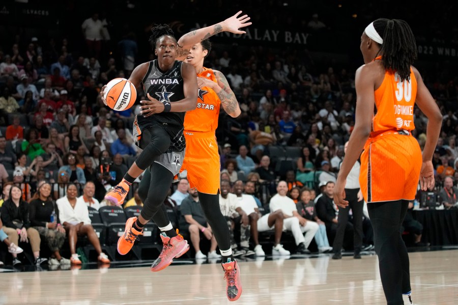 Las Vegas Aces' Chelsea Gray, of Team Wilson, drives around Phoenix Mercury's Brittney Griner, of Team Stewart, during the first half of a WNBA All-Star basketball game Saturday, July 15, 2023, in Las Vegas. (AP Photo/John Locher)