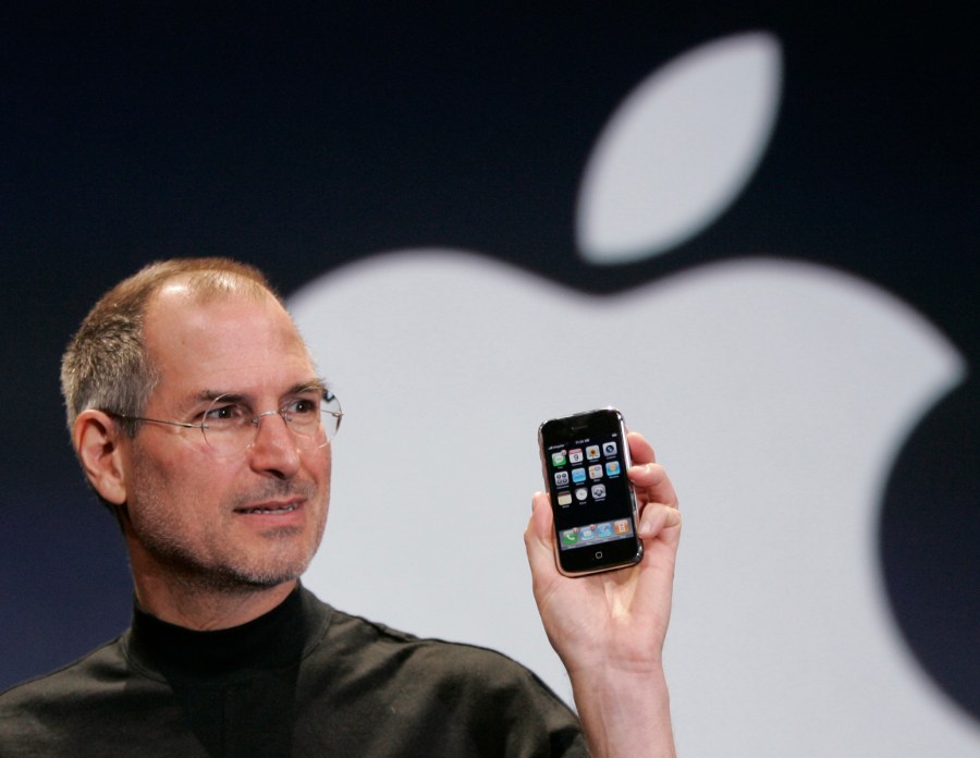 FILE - Apple CEO Steve Jobs holds up an Apple iPhone at the MacWorld Conference, Jan. 9, 2007, in San Francisco. On Sunday, July 16, 2023, a first-generation iPhone sold at auction for $190,373, almost 380 times its original price of $499 when the groundbreaking device went for sale in 2007. (AP Photo/Paul Sakuma, File)