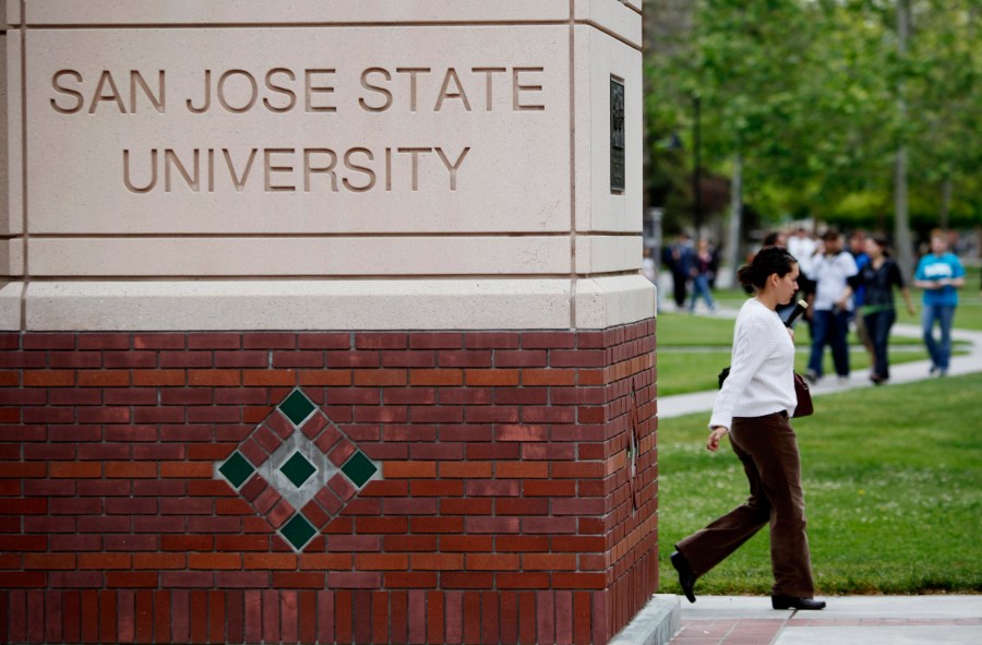 CORRECTS TO SEVEN YEARS INSTEAD OF SIX - FILE - People walk on the campus of San Jose State University in San Jose, Calif., on May 5, 2009. A flawed policy at California State University, the largest higher education system in the country, contributed to the closure of nearly a dozen sexual harassment cases without thorough explanation, a state audit reviewing dozens of cases over the span of seven years found. The state auditor investigated allegations reported by employees at the California State University chancellor's office, California State University, Fresno, San Jose State University and Sonoma State University. (AP Photo/Paul Sakuma, File)