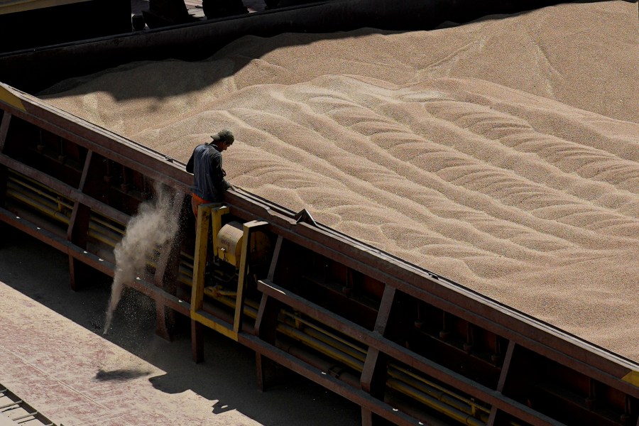 FILE - An employee of the Romanian grain handling operator Comvex oversees the unloading of Ukrainian cereals from a barge in the Black Sea port of Constanta, Romania, on June 21, 2022. Five European Union countries will extend their ban on Ukrainian grain to protect their farmers’ interests. But agriculture ministers from Poland, Slovakia, Hungary, Bulgaria and Romania said Wednesday, July 19, 2023 that food can still move through their land to parts of the world in need after Russia pulled out of a deal allowing Black Sea shipments. (AP Photo/Vadim Ghirda, File)