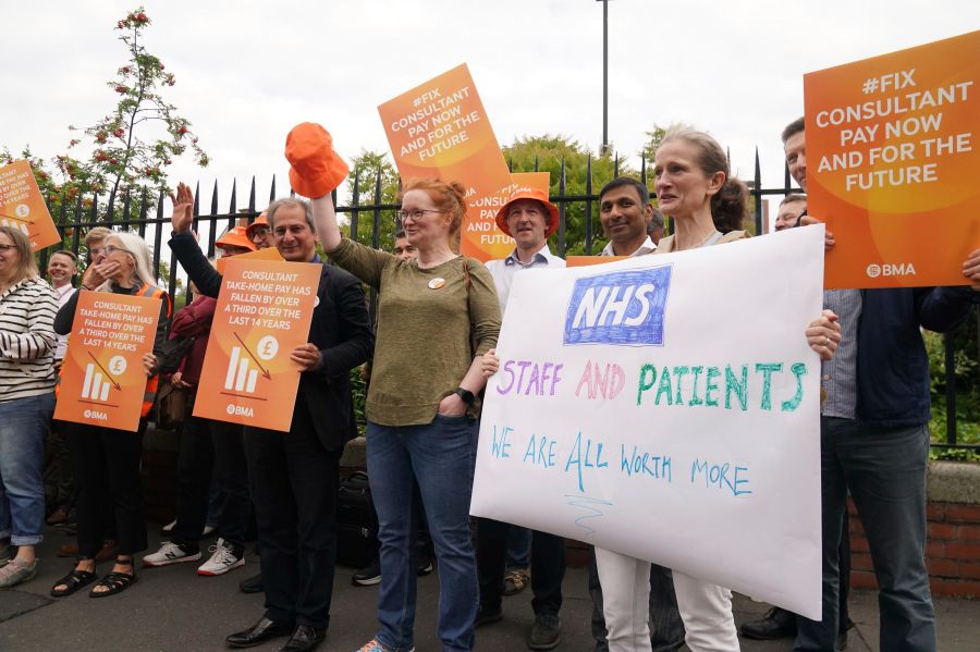 Medical consultant members of the British Medical Association (BMA) on the picket line outside the Royal Victoria Infirmary, Newcastle upon Tyne, as consultants in England are taking industrial action for the first time in more than a decade, Thursday July 20, 2023. (Owen Humphreys/PA via AP)