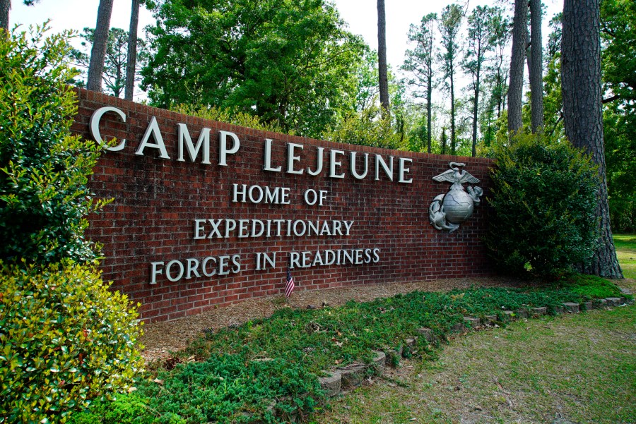 FILE - Signage stands on the main gate to Camp Lejeune Marine Base outside Jacksonville, N.C., Friday, April 29, 2022. Three men who were found dead over the weekend at an eastern North Carolina gas station have been identified as Marine lance corporals stationed nearby at Camp Lejeune, the U.S. Marine Corps said Tuesday, July 25, 2023. (AP Photo/Allen G. Breed, File)