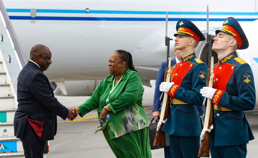 South Africa's President Cyril Ramaphosa, left, shakes hands with South Africa's Foreign Minister Naledi Pandort at Pulkovo International Airport as he arrived to participate the Russia Africa Summit in St. Petersburg, Russia, Wednesday, July 26, 2023. (Peter Kovalev/TASS News Agency Host Pool Photo via AP)