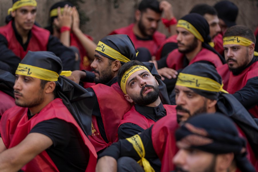 Hezbollah supporters in a sermon listen to the story of Ashoura, the Shiite Muslim commemoration marking the death of Imam Hussein, the grandson of the Prophet Muhammad, at the Battle of Karbala in present-day Iraq in the 7th century, in the southern suburbs of Beirut, Lebanon, Saturday, July 29, 2023. The leader of Lebanon's Hezbollah militant group said Saturday that if the governments of Muslim-majority nations do not take action against countries that allow the desecration of the Quran, it is the responsibility of Muslims to "punish" those who facilitate attacks on the Islamic holy book. (AP Photo/Hassan Ammar)