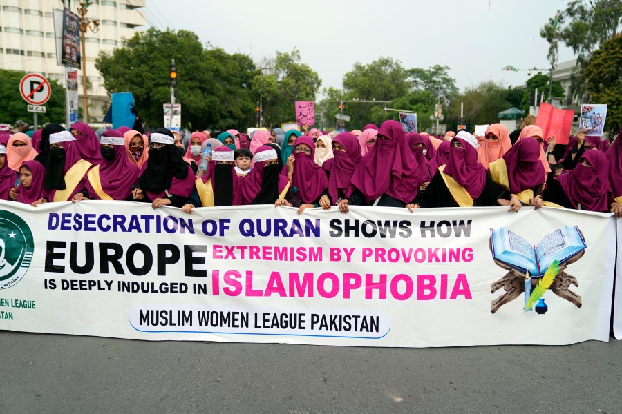 Pakistan Muslim Women League members chant slogans during a rally to denounce the recent burning of the holy book 'Quran' that took place in Sweden, Tuesday, July 18, 2023, in Lahore, Pakistan. (AP Photo/K.M. Chaudary)