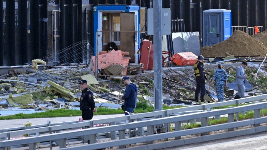 Investigators examine a damaged building after a reported drone attack in Moscow, Russia, Monday, July 24, 2023.