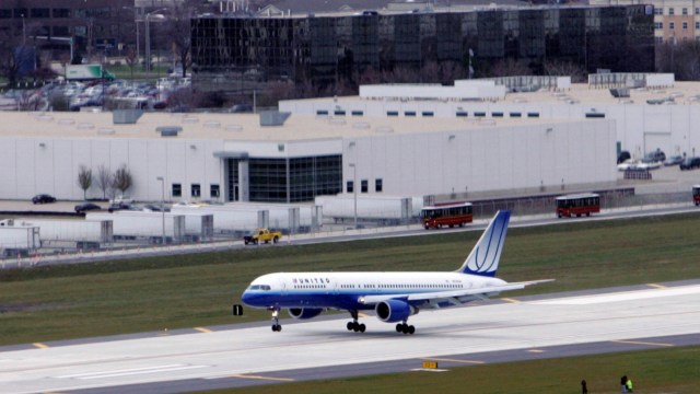 File - A United Airlines plane lands on the new runway at O'Hare International airport in Chicago, Thursday, Nov. 20, 2008.