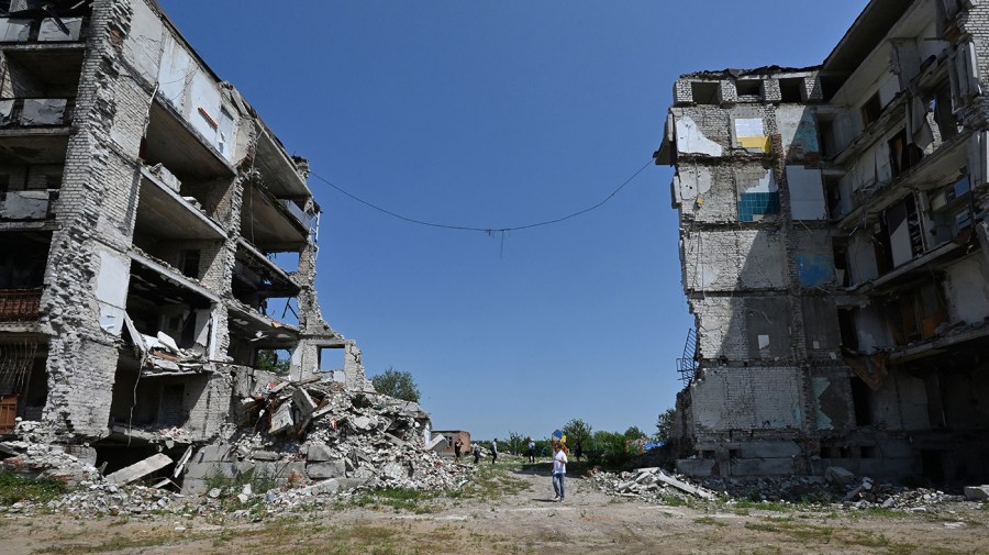 A man walks among destroyed buildings in Izyum, Kharkiv region on July 27, 2023, amid Russian invasion in Ukraine. (Photo by SERGEY BOBOK / AFP) (Photo by SERGEY BOBOK/AFP via Getty Images)