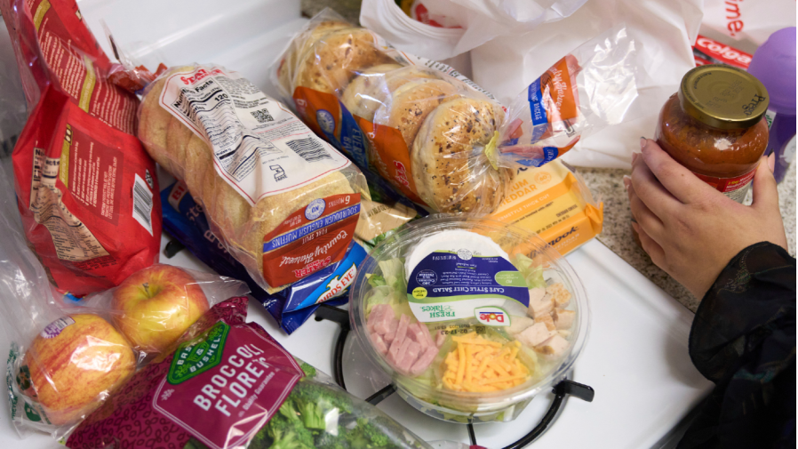 Jaqueline Benitez puts away groceries at her home in Bellflower, Calif., on Monday, Feb. 13, 2023. (AP Photo/Allison Dinner)