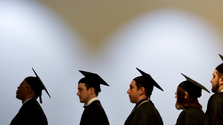 Augusta University students line up before entering the James Brown Arena to get their diplomas during their graduation ceremony on May 11, 2018, in Augusta, Ga. (Michael Holahan/The Augusta Chronicle via AP, File)