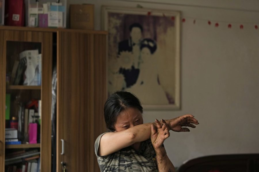 Li Mingle wipes tears as she recalls the desperate situation during the floods that swept through Nanxinfang village on the outskirts of Beijing, Friday, Aug. 4, 2023. Heavy rain and high water levels on rivers in northeastern China were threatening cities downstream on Friday, prompting the evacuation of thousands, although the country appears to have averted the worst effects of the typhoon season battering parts of east Asia. (AP Photo/Ng Han Guan)