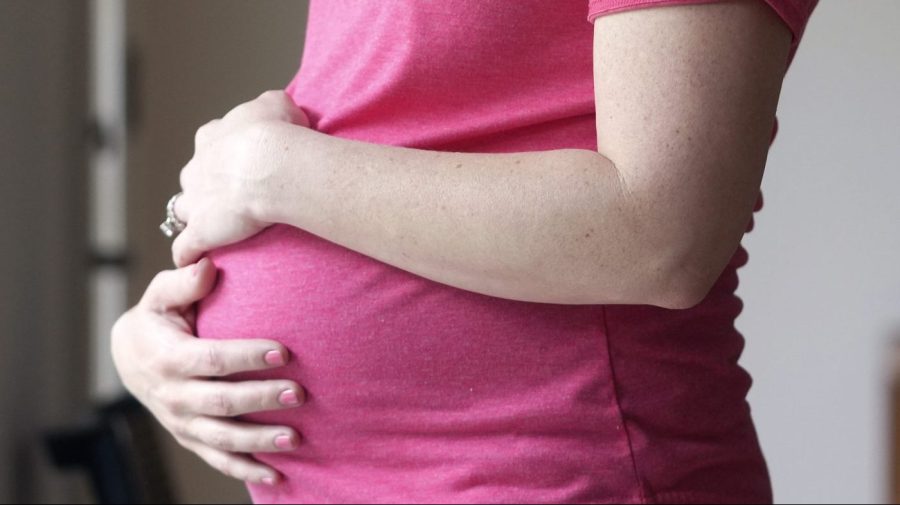 FILE - A pregnant woman stands for a portrait in Dallas, Thursday, May 18, 2023. On Friday, Aug. 4, 2023, U.S. health officials approved the first pill, Zurzuvae, specifically intended to treat severe depression after childbirth, a condition that affects thousands of new mothers in the U.S. each year. (AP Photo/LM Otero, File)