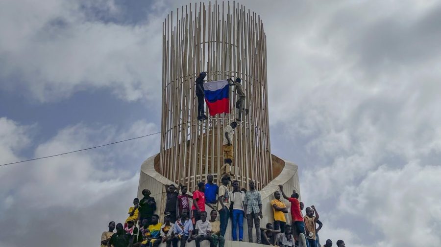 Supporters of Niger's ruling junta hold a Russian flag at the start of a protest called to fight for the country's freedom and push back against foreign interference in Niamey, Niger, Thursday, Aug. 3, 2023. The march falls on the West African nation's independence day from its former colonial ruler, France, and as anti-French sentiment spikes, more than one week after mutinous soldiers ousted the country's democratically elected president. (AP Photo/Sam Mednick)