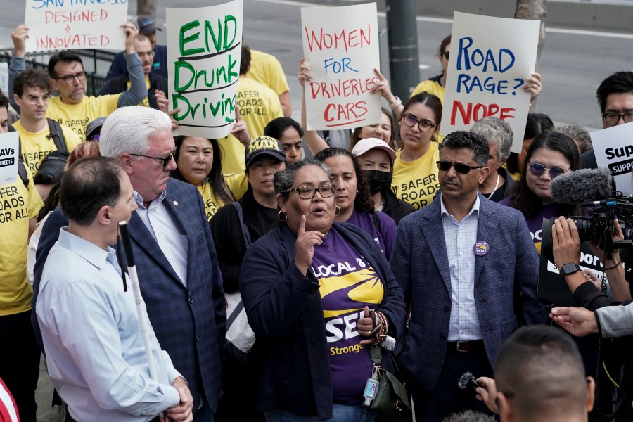 SEIU Local 87 president Olga Miranda, center, speaks in support of a proposed robotaxi expansion on Thursday, Aug. 10, 2023, in San Francisco. (AP Photo/Godofredo A. Vásquez)