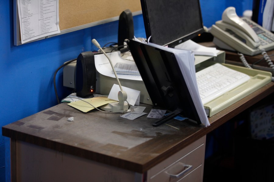 An empty spot on reporter Phyllis Zorn's desk shows where the tower for her computer sat before law enforcement officers seized it in a raid on the Marion County Record, Sunday, Aug. 13, 2023, in Marion County, Kan. Editor and Publisher Eric Meyer says the raid was designed to intimidate the newspaper as it investigated local issues. (AP Photo/John Hanna)