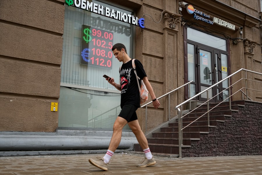 A man walks past a currency exchange office in Moscow, Russia, Monday, Aug. 14, 2023. The Russian ruble has reached its lowest value since the early weeks of the war in Ukraine as Western sanctions weigh on energy exports and weaken demand for the national currency. The Russian currency passed 101 rubles to the dollar on Monday, continuing a more than 25% decline in its value since the beginning of the year. (AP Photo/Alexander Zemlianichenko)