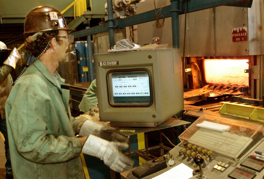 File - Bob Simmons monitors the controls for a furnace and rolling machine at the US Steel research and development facility in Monroeville, Pa., on June 6, 2005. With two bidders revealed in a matter of days and more in the wings, United States Steel Corp. seems poised to be purchased by a competitor sooner than later. (AP Photo/Keith Srakocic, File)