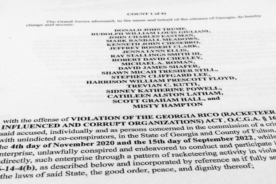 The indictment in Georgia against former President Donald Trump is photographed Tuesday, Aug. 15, 2023. After every indictment that has come his way, Trump has boasted that his standing among Republicans only improves — and he has a point. Nearly two-thirds of Republicans — 63% — say they want the former president to run again, according to new polling from The Associated Press-NORC Center for Public Affairs Research.(AP Photo/Jon Elswick)