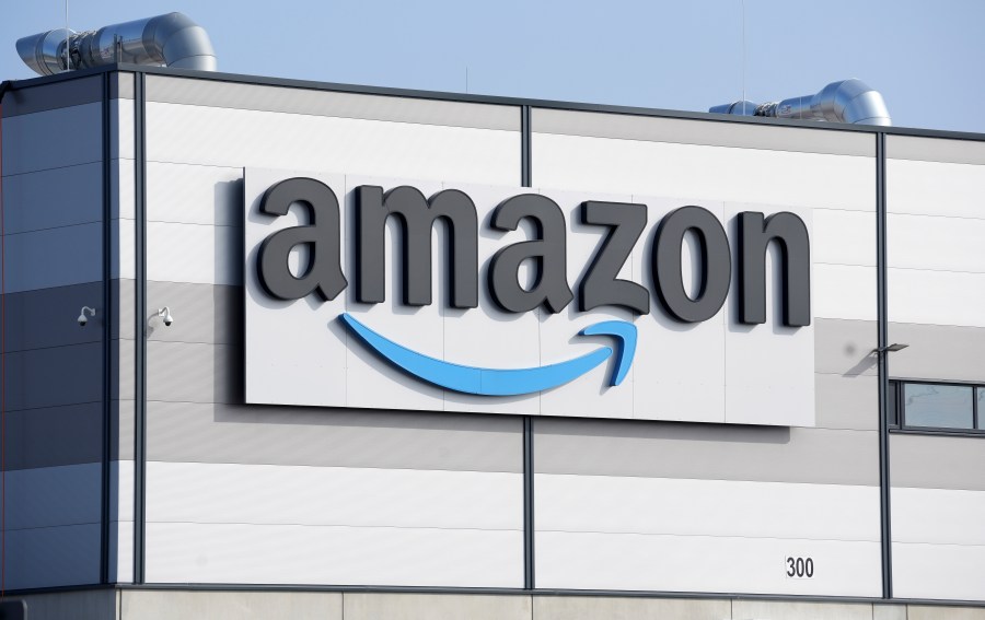 FILE - An Amazon company logo marks the facade of a building in Schoenefeld near Berlin, March 18, 2022. Amazon will impose new fees on third-party sellers who ship their products to customers instead of using the company’s fulfillment service. (AP Photo/Michael Sohn, File)