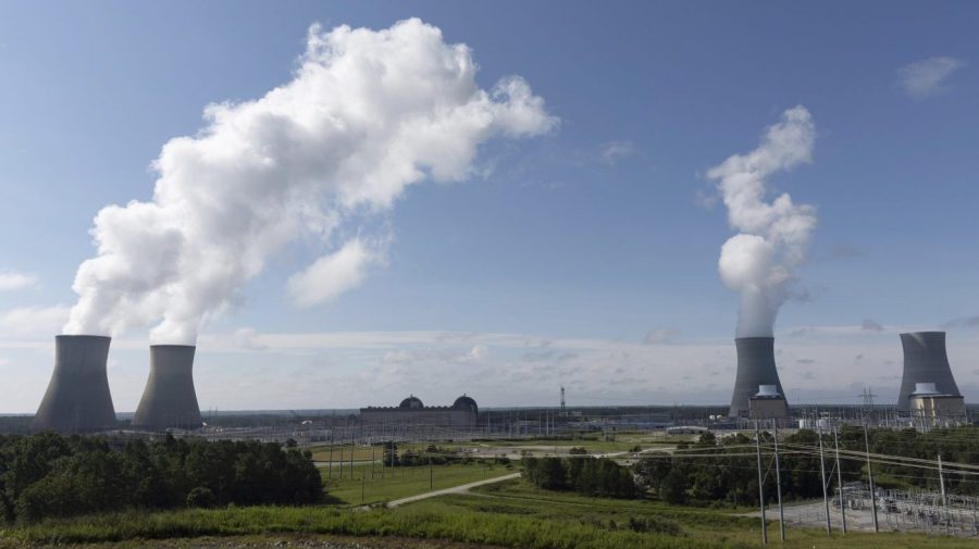 FILE - Nuclear reactors and cooling towers of the four units of Plant Vogtle, a nuclear plant near Waynesboro, Ga., are shown on July 31, 2023. Georgia Power Co. announced Thursday, Aug. 17, 2023, that Unit 4, at far right, is loading fuel, with the aim of sending power to the grid reliably by March 2024. Unit 4 and the now-operating Unit 3 and Unit 4 are the first new American reactors built from scratch in decades. (Arvin Temkar/Atlanta Journal-Constitution via AP, File)