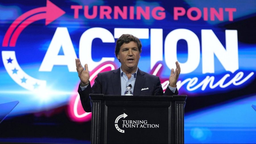 FILE - Tucker Carlson speaks at the Turning Point Action conference, Saturday, July 15, 2023, in West Palm Beach, Fla. Former President Donald Trump's decision to back out of Fox News' first GOP primary debate this week likely costs the network a chance at a very large audience for the end of summer. It also tests the network's ability to pivot yet again after what has been a tough year, paying $787 million to settle a defamation lawsuit just as a trial was to begin, and firing popular personality Tucker Carlson shortly after the settlement. (AP Photo/Lynne Sladky, File)