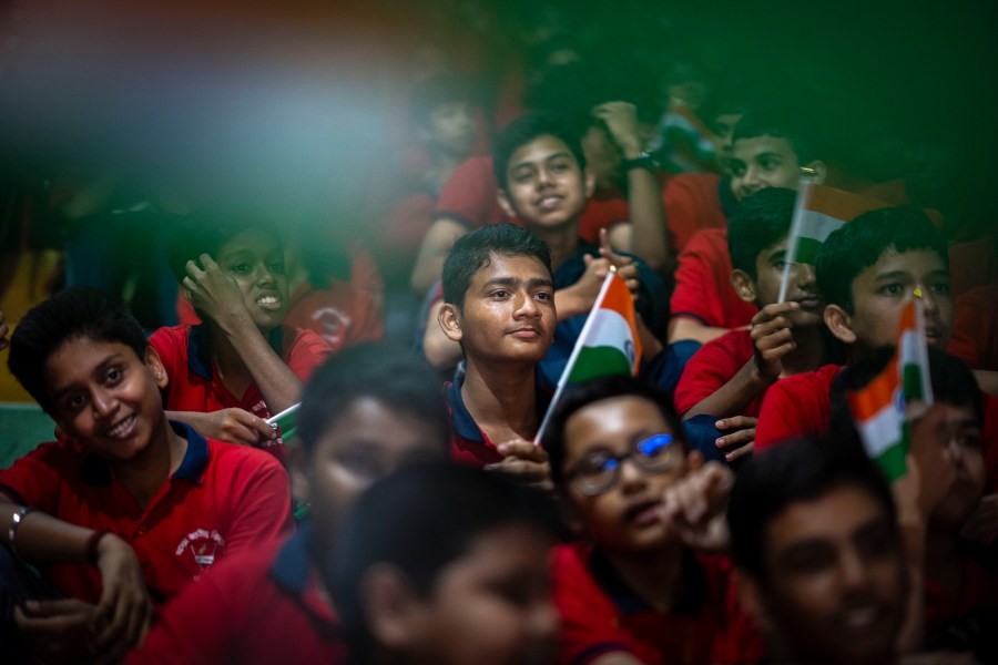 Schoolchildren celebrate the successful landing of spacecraft Chandrayaan-3 on the moon, in a school in Guwahati, India, Wednesday, Aug. 23, 2023. India has landed a spacecraft near the moon's south pole, an unchartered territory that scientists believe could hold vital reserves of frozen water and precious elements, as the country cements its growing prowess in space and technology. (AP Photo/Anupam Nath)