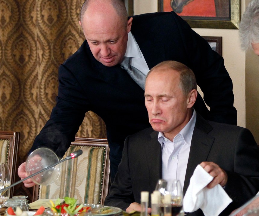 FILE - Yevgeny Prigozhin, top, serves food to then-Russian Prime Minister Vladimir Putin at Prigozhin's restaurant outside Moscow, Russia, on Nov. 11, 2011. Prigozhin made his name as the profane and brutal mercenary boss who mounted an armed rebellion that was the most severe and shocking challenge to Russian President Vladimir Putin’s rule. (AP Photo/File)