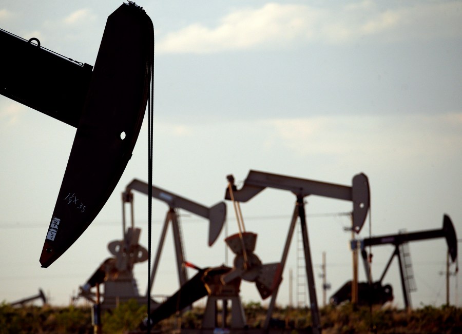 FILE - Pump jacks work in a field near Lovington, N.M., April 24, 2015. Record-breaking oil production in New Mexico is likely to provide state government with a new multibillion-dollar surplus during the upcoming budget year, economists for the state announced Wednesday, Aug. 23, 2023. (AP Photo/Charlie Riedel, File)