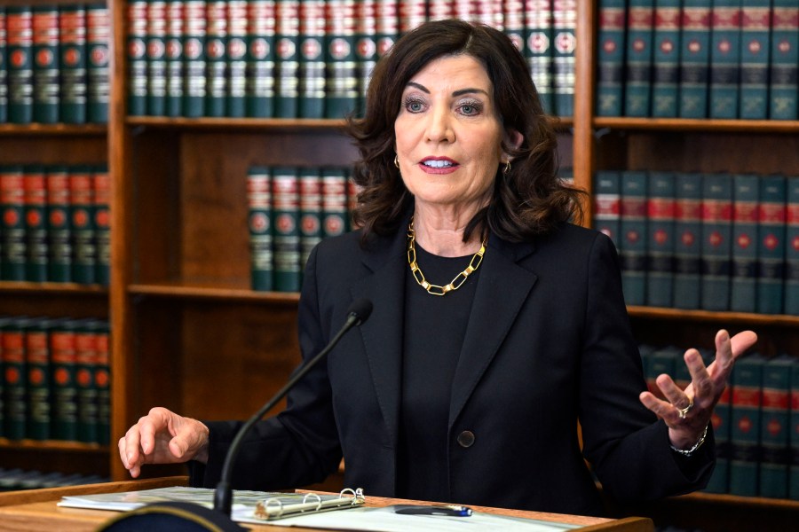 FILE - New York Gov. Kathy Hochul speaks to reporters about end of session legislative bills and a swearing-in ceremony, June 7, 2023, in Albany, N.Y. On Thursday, Aug. 24, Hochul implored President Joe Biden to take urgent action to help her state absorb a surge of international migrants who have strained resources and filled homeless shelters — putting some Democrats in a vulnerable position in a state usually seen as immigrant-friendly. (AP Photo/Hans Pennink, File)