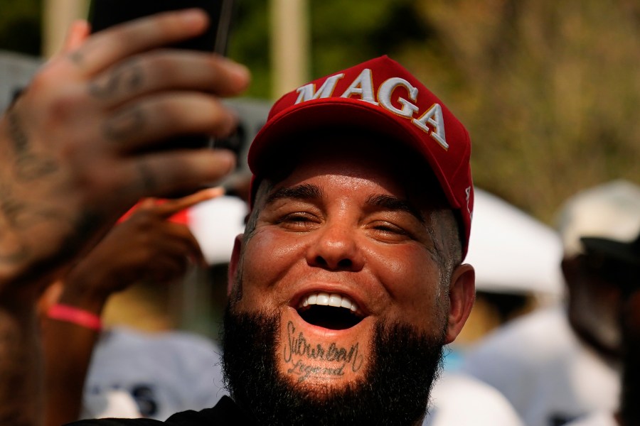 A supporter of former President Donald Trump stands outside of the Fulton County Jail, Thursday, Aug. 24, 2023, in Atlanta. (AP Photo/Brynn Anderson)