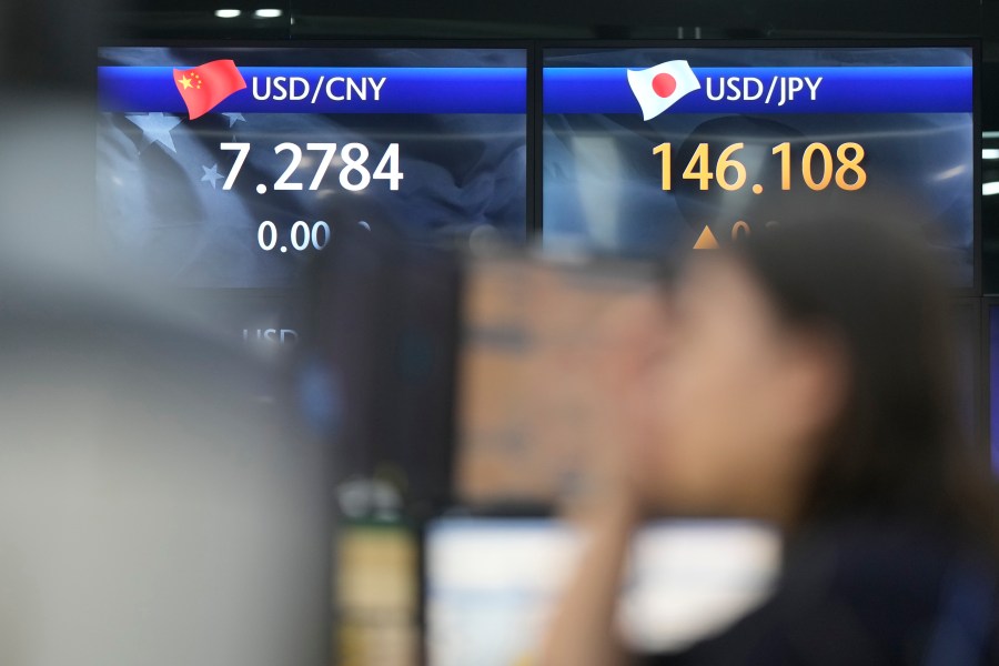 A currency trader watches computer monitors near the screens showing the foreign exchange rates at a foreign exchange dealing room in Seoul, South Korea, Friday, Aug. 25, 2023. Asian shares mostly fell Friday, discouraged by a Wall Street slump that followed a blowout profit report from Nvidia and mixed reports on the U.S. economy. (AP Photo/Lee Jin-man)