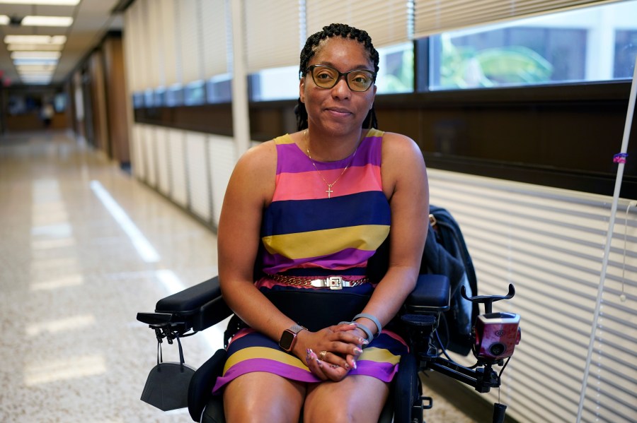 Kimberlyn Barton-Reyes, who is paraplegic and visually impaired, poses for a photo at a rehabilitation center, Wednesday, Aug. 23, 2023, in Austin, Texas. For Barton-Reyes, the Affordable Connectivity Program is a lifeline and its one-time allocation of $14.2 billion is projected to run out by the middle of 2024. That could end access to affordable broadband for her and more than 20 million households. (AP Photo/Eric Gay)