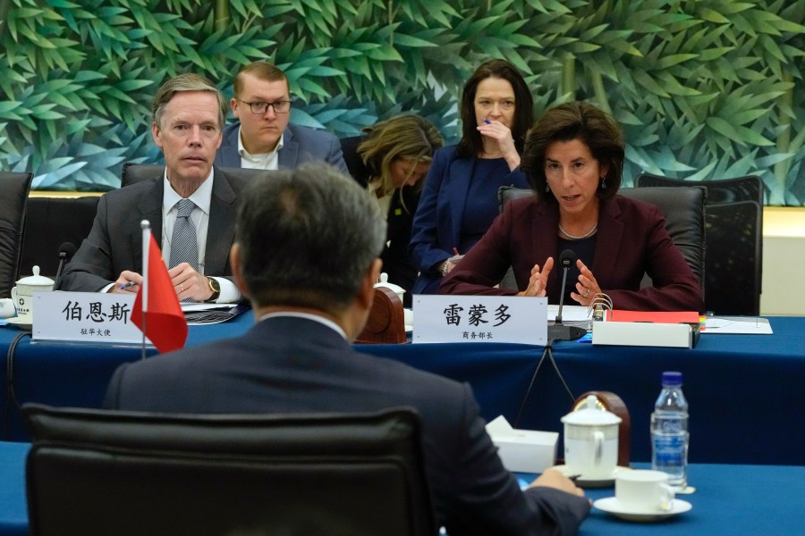 U.S. Commerce Secretary Gina Raimondo, right, speaks next to U.S. Ambassador to China Nick Burns, left, during a meeting with China's Minister of Commerce Wang Wentao, foreground, at the Ministry of Commerce in Beijing, Monday, Aug. 28, 2023. (AP Photo/Andy Wong, Pool)