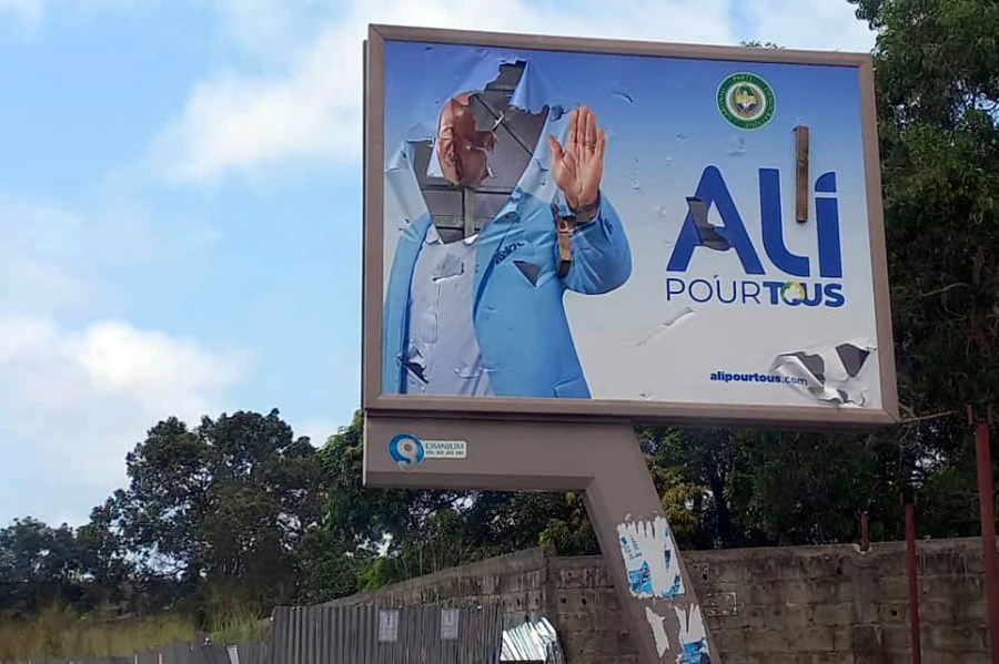 A defaced billboard of Gabon President Ali Bongo Ondimba is seen on an empty street in Libreville, Gabon, Wednesday Aug. 30, 2023. Mutinous soldiers speaking on state television announced that they had seized power in and were overturning the results of a presidential election that was to extend the Bongo family's 55-year hold on power. (AP Photo/Yves Laurent)