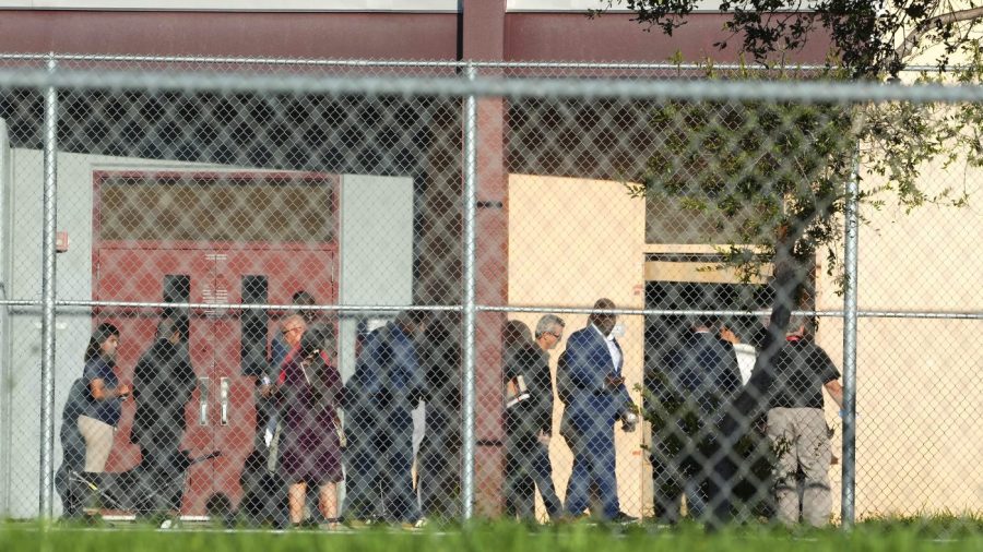 Nine members of Congress and others enter to enter Marjory Stoneman Douglas High School, Friday, Aug. 4, 2023, in Parkland, Fla.