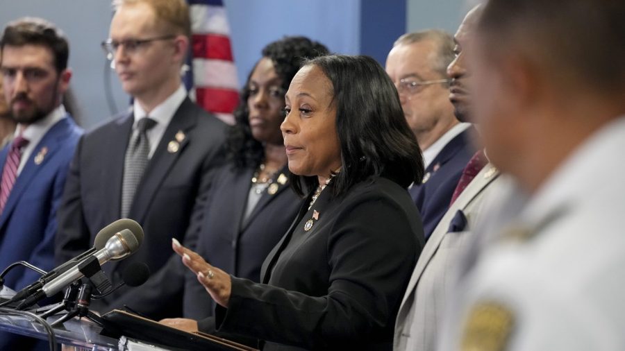 Fulton County District Attorney Fani Willis, center, speaks in the Fulton County Government Center during a news conference, Monday, Aug. 14, 2023, in Atlanta. Donald Trump and several allies have been indicted in Georgia over efforts to overturn his 2020 election loss in the state.