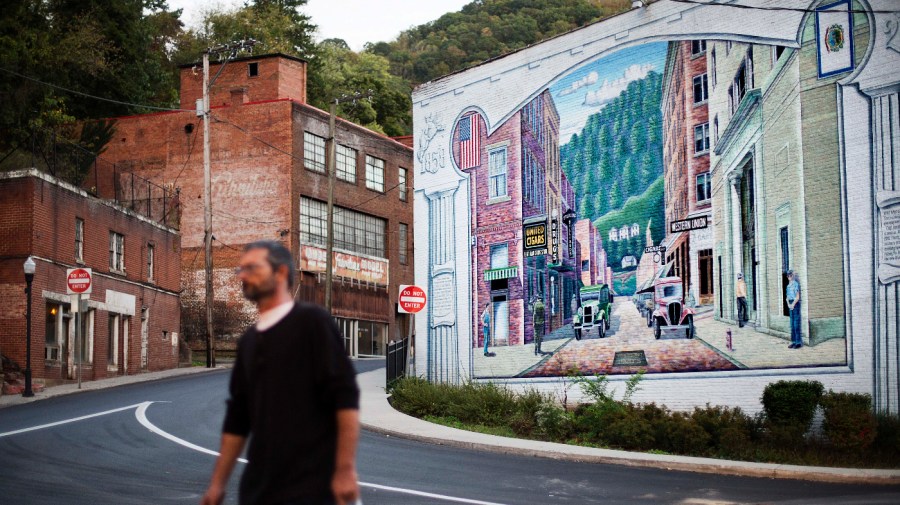 A mural depicting a more vibrant time in the town's history decorates a building in the business district, Tuesday, Oct. 6, 2015, in Welch, W.Va.