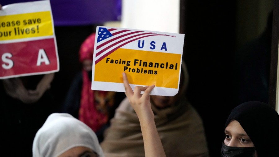 Afghan refugees hold placards during a gathering in Islamabad, Pakistan, Friday, July 21, 2023. Hundreds of Afghan refugees facing extreme delays in the approval of U.S. visas are protesting in Pakistan's capital, as an American program to help relocate at-risk Afghans fleeing Taliban rule stalls. (AP Photo/Rahmat Gul)