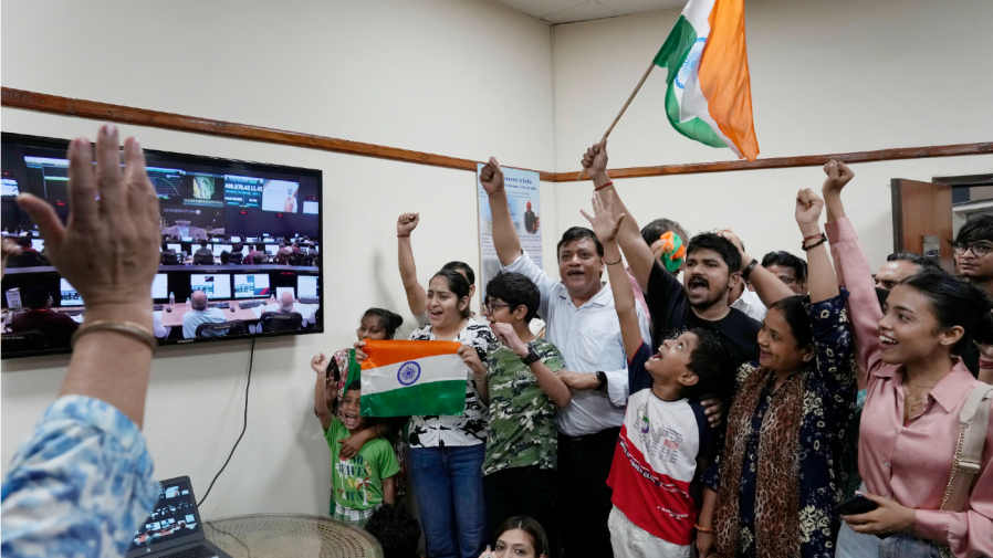 Indians celebrate the successful landing of Chandrayaan-3, or “moon craft” in Sanskrit, at the Nehru Planetarium in New Delhi, India, Wednesday, Aug. 23, 2023. India has landed a spacecraft near the moon’s south pole, an unchartered territory that scientists believe could hold vital reserves of frozen water and precious elements, as the country cements its growing prowess in space and technology. (AP Photo/Manish Swarup)