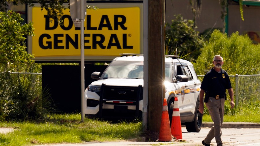 Law enforcement officials continue their investigation at a Dollar General Store that was the scene of a mass shooting, Sunday, Aug. 27, 2023, in Jacksonville, Fla.